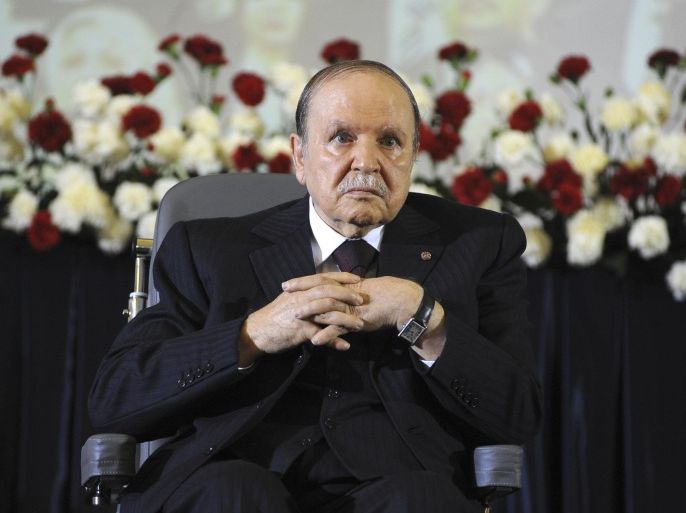 Algerian President Abdelaziz Bouteflika sits on a wheelchair to take the oath as President, Monday, April 28, 2014, in Algiers. Algeria's president has taken his oath of office for a fourth term from his wheelchair following his election win earlier this month. The president, in power since 1999, received more than 81 percent of the vote in the April 17 election in this key North African energy producer. (AP Photo/Sidali Djarboub)