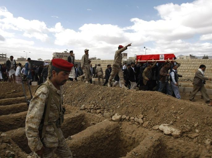 Yemeni mourners carry the coffins of soldiers who were killed by suspected al-Qaida militants at a checkpoint in Hadramawt province, during their funeral in Sanaa, Yemen, Sunday, March 30, 2014. Suspected al-Qaida militants attacked a security checkpoint in southeastern Yemen, first sending in a suicide car bomb then storming it, officials said on March 24. They killed 22 troops and left only one survivor, who pretended he was dead. (AP Photo/Hani Mohammed)
