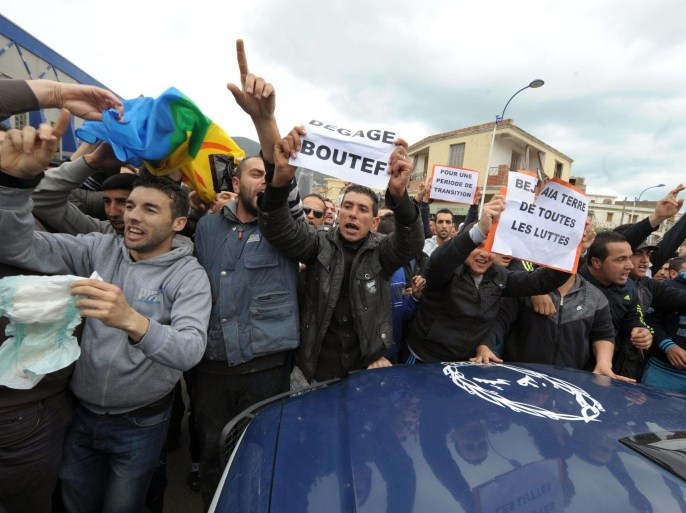 Protestors shout and hold placards, in Bejaia, eastern Algeria, Saturday, April 5, 2014. Demonstrators call for a boycott of the upcoming presidential election as twelve candidates have registered for Algeria’s April 17 presidential election including President Abdelaziz Bouteflika, 77, who is running for a fourth term. Placard center left, reads "Bouteflika get out". (AP Photo/ Sidali Djarboub)
