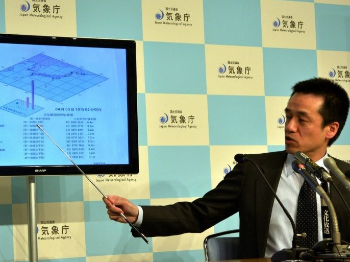 Japan Meteorological Agency officer Yohei Hsegawa speaks about a tsunami at a press conference at the agency in Tokyo on August 3, 2014. Small tsunami waves hit northern Japan following a powerful 8.2-magnitude earthquake thousands of kilometres away across the Pacific Ocean in Chile. The agency said waves of 40 centimetres were monitored in Kuji port in Iwate prefecture, northern Japan. AFP PHOTO / Yoshikazu TSUNO