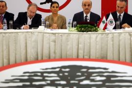 Strida Geagea, center third left, the wife of Samir Geagea, the leader of the Christian Lebanese Forces party, second right, attend a meeting with senior party officials to announce his candidacy for the Lebanese presidency, in Maarab east Beirut, Lebanon, Friday April 4, 2014. A former Lebanese warlord who now leads a Christian right-wing party has announced he will run for president in the tiny Arab country's elections later this spring. According to Lebanon's power-sharing system, the president must be a Maronite Christian, the prime minister a Sunni Muslim and the parliament speaker a Shiite Muslim. (AP Photo/Hussein Malla)