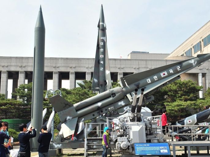 Visitors look at replicas of North Korean Scud-B missile (L) and South Korean Nike missiles at the Korean War Memorial in Seoul on March 26, 2014. North Korea test-fired two medium-range ballistic missiles on March 26, prompting a stern US reaction after President Barack Obama hosted a landmark Japan-South Korea summit aimed at uniting the three allies against Pyongyang's nuclear threat. AFP PHOTO / JUNG YEON-JE