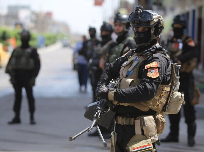 Members of Iraq's anti-terrorism force are deployed outside polling stations in central Baghdad on April 29, 2014, one day ahead of Iraq's first general election since US troops withdrew. The bloodshed across Iraq the previous day, which involved nine suicide bombings and several other blasts, raised questions over whether Iraq's security forces can protect upwards of 20 million eligible voters during this week's polls. AFP/ PHOTO/AHMAD AL-RUBAYE
