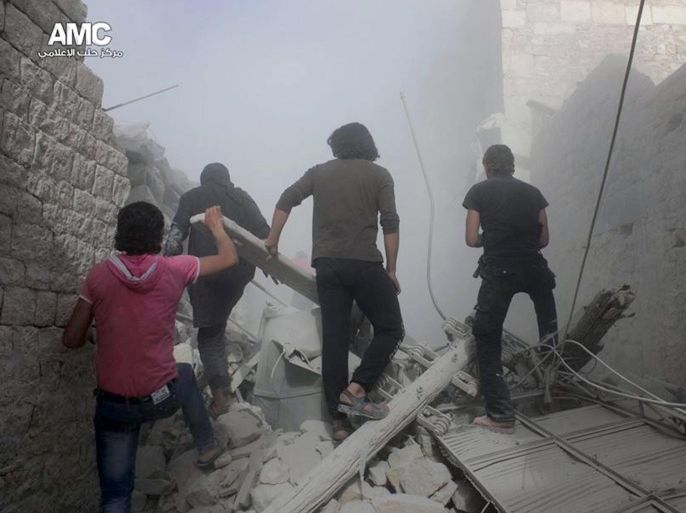 This Sunday, April 27, 2014 photo provided by the anti-government activist group Aleppo Media Center (AMC), which has been authenticated based on its contents and other AP reporting, shows Syrians inspecting the rubble of a destroyed buildings following a Syrian government airstrike in Aleppo, Syria. Dozens of people were killed and wounded in fighting between pro-Assad forces and rebels in the northern city of Aleppo on Sunday, reported the Britain-based Syrian Observatory for Human Rights. The fight for Aleppo is particularly important now, with analysts saying they expect Assad's forces will try wrest as much of the city as possible before elections. (AP Photo/Aleppo Media Center AMC)