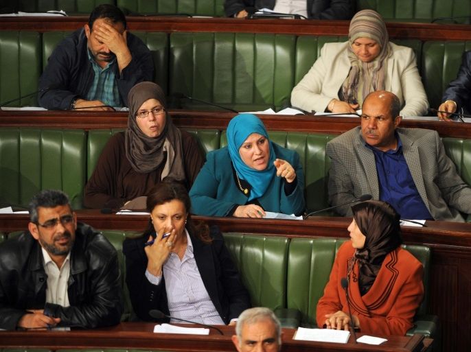 Tunisian members of parliament from the Ennahdha party attend a parliament session to debate Tunisia's electoral law, which will pave the way for polls due to take place by the end of the year on April 18, 2014 in Tunis. The Tunisian National Constituent Assembly (NCA) began to vote article by article on the future electoral law, which is needed to hold the legislative and presidential elections before the end of 2014. AFP PHOTO / FETHI BELAID