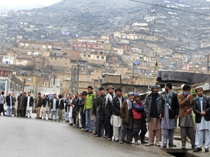Afghan men line up outside a polling station to cast their ballots, in Kabul, Afghanistan, Saturday, April 5, 2014. Afghan voters lined up for blocks at polling stations nationwide on Saturday, defying a threat of violence by the Taliban to cast ballots in what promises to be the nation's first democratic transfer of power. (AP Photo/Rahmatullah Nikzad)