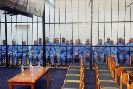 Former Libyan intelligence chief Abdullah al-Senussi (L), and former Libyan foreign intelligence chief Bouzid Dorda (2nd L) and other members of the former Libyan regime, attend their trial at the appeals court in Tripoli, on April 14, 2014. The main charges against the suspects include murders committed during the regime's battle against the revolt that erupted in the eastern city of Benghazi in February 2011. AFP PHOTO/MAHMUD TURKIA