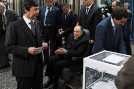 Algeria's ailing President Abdelaziz Bouteflika running for re-election, watches after casting his ballot from a wheelchair as his brothers Said (L), who serves as special adviser, and Nasser (R) vote at a polling station in Algiers on April 17, 2014. Algerians were voting in presidential elections, with Bouteflika widely expected to win a fourth term despite chronic health problems, fraud warnings and calls for a boycott. AFP PHOTO / FAROUK BATICHE