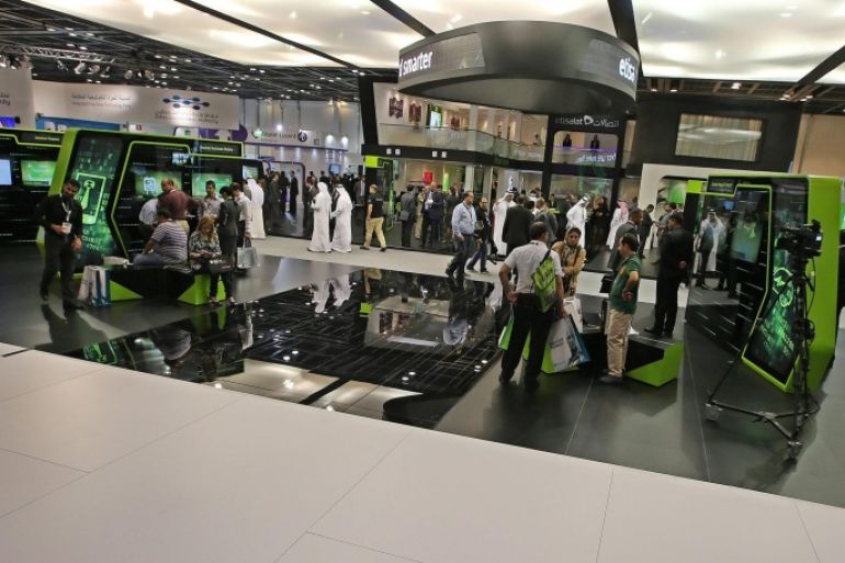 Visitors inspect Emiriti Etisalat section at Gulf Information Technology Exhibition (GITEX) exhibition 2013 in Gulf emirate of Dubai, United Arab Emirates on 21 October 2013. GITEX, one of the most important in the electronics exhibition and conference, runs from 20 to 24 October. More than 135,000 ICT professionals from 150 countries are expected to visit.