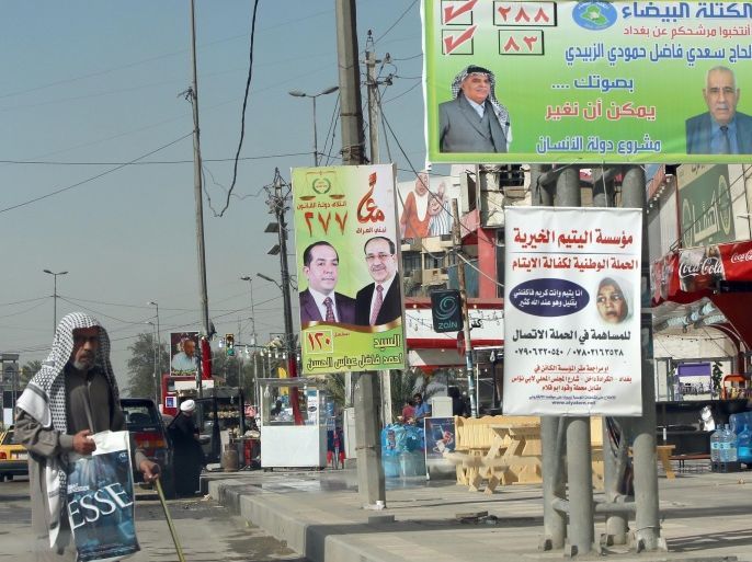 Election posters hang on pylons along a sidewalk in the Iraqi capital Baghdad, on April 1, 2014. Campaigning for Iraq's April 30 general election opened with Prime Minister Nuri al-Maliki bidding for a third term as his government grapples with the country's worst bloodshed in years. AFP PHOTO/ ALI AL-SAADI