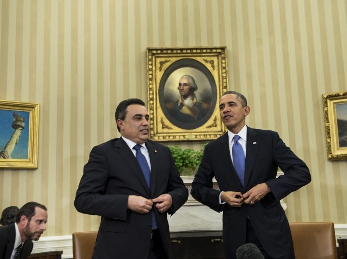 Tunisian Prime Minister Mehdi Jomaa (L) and US President Barack Obama stand up after making statements to the press before a meeting in the Oval Office of the White House on April 4, 2014 in Washington, DC. AFP PHOTO/Brendan SMIALOWSKI
