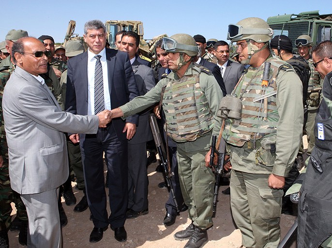 A handout picture released by the Tunisian Presidency on May 6, 2014, shows Tunisian President Moncef Marzouki (L) greeting soldiers during a visit in Tunisia's restive Mount Chaambi border region, where Tunisian forces are stationed as part of an operation against Islamist militants. Since late 2012, security forces have been battling dozens of militants hiding out in the Mount Chaambi region, just a few kilometres (miles) from the border with Algeria. AFP