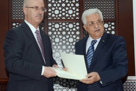A photograph provided by the Palestinian Authority shows Palestinian Prime Minister Rami Hamdallah (L) in the Palestinian Authority's headquarters in the West Bank town of Ramallah, 29 May 2014, as he is tasked by Palestinian President Mahmoud Abbas (R) to form the new Palestinian cabinet to be comprised of technocrats, in the coming five weeks. EPA/THAER GHANAIM / PALESTINIAN AUTH