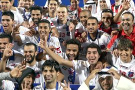 Kuwait's Kuwait SC players celebrate with the trophy after winning the AFC Cup final match against Al-Qadseyya at the Al-Sadaqua Walsalam Stadium near Kuwait City on November 2, 2013. AFP PHOTO/YASSER AL-ZAYYAT