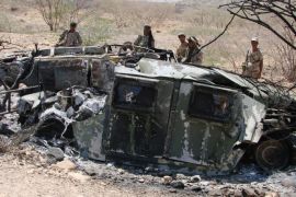 In this Friday, May 1, 2014, photo provided by Yemen's Defense Ministry, soldiers inspect the wreckage of vehicles destroyed during fighting with al-Qaida militants in Majala of the southern province of Abyan, Yemen. (AP Photo/Yemen's Defense Ministry)