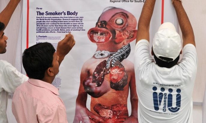 Indian health volunteers from the World Health Organisation display the Smokers Body poster prior to an anti smoking rally on the eve of the 'World No tobacco Day' created by the WHO in Hyderabad on May 31, 2011. India is the world's second-largest producer and consumer of tobacco behind China, according to the American Cancer Society and the World Lung Foundation. An estimated 241 million people in India use tobacco in some form.