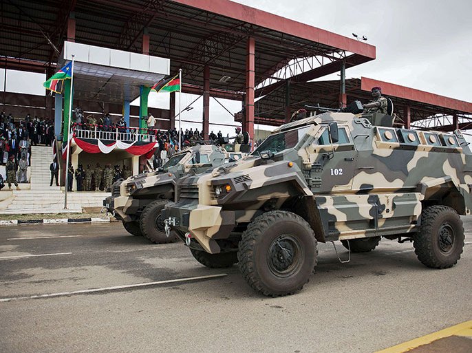 South Sudanese soldiers drive armoured personel carriers during a parade to celebrate the 31st anniversary of the Sudan People Liberation's Army/Movement (SPLA/M) forming at the Dr John Garang memorial mausoleum in Juba on May 16, 2014. The SPLA were formed in 1983 as a guerrilla movement during the second Sudanese civil war. As of 2013, the SPLA was estimated to have 210,000 soldiers. Following South Sudan's independence in 2011, the SPLA became the new republic's regular army. Recent conflict in the country has claimed thousands and possibly tens of thousands of lives, with over 1.2 million people forced to flee their homes as the SPLA battle rebel opposition groups. AFP