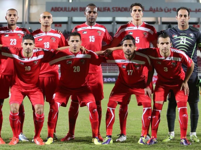 Palestine's starting eleven pose for a picture ahead of their match in the 8th West Asia Football Federation (WAFF) championship against Saudi Arabia in Doha, on December 28, 2013. AFP PHOTO / AL-WATAN DOHA / KARIM JAAFAR == QATAR OUT ==