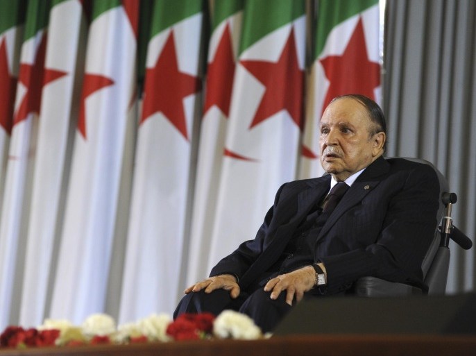 Algerian President Abdelaziz Bouteflika sits on a wheelchair after taking oath as President, Monday, April 28, 2014, in Algiers. Algeria's president has taken his oath of office for a fourth term from his wheelchair following his election win earlier this month. The president, in power since 1999, received more than 81 percent of the vote in the April 17 election in this key North African energy producer. (AP Photo/Sidali Djarboub)