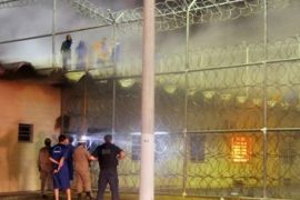 In this photo released by Secretaria de Estado de Seguranca Publica de Sergipe, prisoners stand on the roof of the Advogado Antonio Jacinto Filho state prison, in Aracaju, Brazil, Monday April 16, 2012. Brazil's state news agency says that inmates armed with pistols and knives have rioted at a prison in the country's northeast region and are holding about 100 visitors and several guards hostage. The agency says the inmates are demanding an end to acts of torture they allege regularly take place inside the prison, as well as better treatment of female visitors.