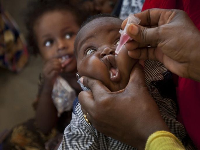 FILE-- In this file photo dated Wednesday April 24, 2013, a Somali child receives a polio vaccine, at the Medina Maternal Child Health center in Mogadishu, Somalia. In an announcement Monday May 5, 2014, the World Health Organization (WHO) says the spread of polio is an international public health emergency that threatens to infect other countries with the crippling disease and could ultimately unravel the nearly three-decade effort to eradicate it, describing the ongoing polio outbreaks in Asia, Africa and the Middle East as an "extraordinary event" requiring a coordinated international response.(AP Photo/Ben Curtis, FILE)
