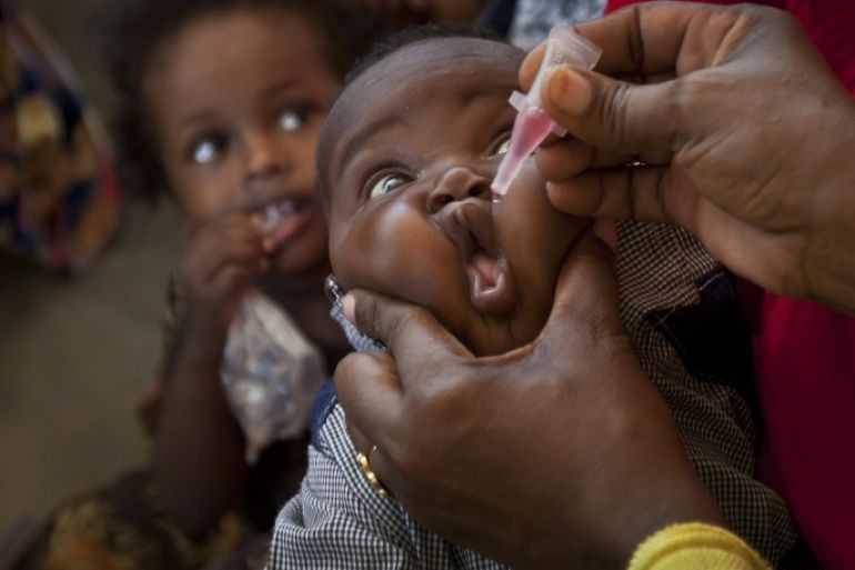 FILE-- In this file photo dated Wednesday April 24, 2013, a Somali child receives a polio vaccine, at the Medina Maternal Child Health center in Mogadishu, Somalia. In an announcement Monday May 5, 2014, the World Health Organization (WHO) says the spread of polio is an international public health emergency that threatens to infect other countries with the crippling disease and could ultimately unravel the nearly three-decade effort to eradicate it, describing the ongoing polio outbreaks in Asia, Africa and the Middle East as an "extraordinary event" requiring a coordinated international response.(AP Photo/Ben Curtis, FILE)