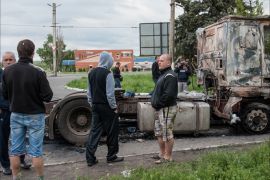 2593 Local people walk near a burnt truck after a shooting in Slaviansk, Ukraine, 05 May 2014.