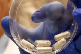 Dr. Thomas Louie, an infectious disease specialist at the University of Calgary, holds a container of stool pills in triple-coated gel capsules in his lab in Calgary, Alberta, Canada on Thursday, Sept. 26, 2013. Half a million Americans get Clostridium difficile, or C-diff, infections each year, and about 14,000 die. A very potent and pricey antibiotic can kill C-diff but also destroys good bacteria that live in the gut, leaving it more susceptible to future infections. Recently, studies have shown that fecal transplants - giving infected people stool from a healthy donor - can restore that balance. (AP Photo/The Canadian Press, Jeff McIntosh)