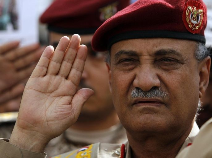 Yemen's Defense Minister, Maj. Gen. Mohammed Nasser Ahmed leads the national flag salute on during a funeral service in Sanaa for military personnel killed after tribal militants shot down a military helicopter in Marib province, 173 km east of the capital, August 7, 2013. REUTERS/Mohamed al-Sayaghi (YEMEN - Tags: MILITARY OBITUARY)