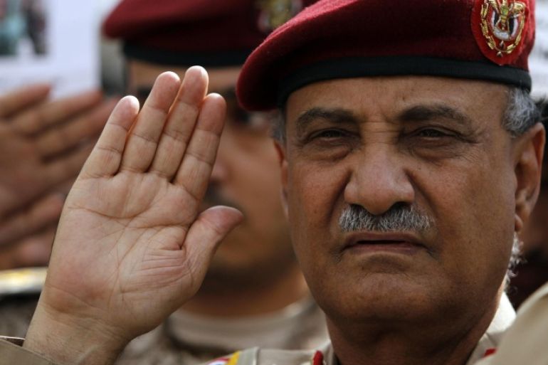 Yemen's Defense Minister, Maj. Gen. Mohammed Nasser Ahmed leads the national flag salute on during a funeral service in Sanaa for military personnel killed after tribal militants shot down a military helicopter in Marib province, 173 km east of the capital, August 7, 2013. REUTERS/Mohamed al-Sayaghi (YEMEN - Tags: MILITARY OBITUARY)
