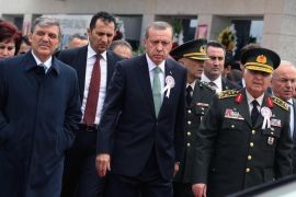 Turkish Prime Minister Recep Tayyip Erdogan, center, President Abdullah Gul, left, and Chief of Staff Gen. Necdet Ozel, right, leave a meeting in Ankara, Turkey, Saturday, May 10, 2014, Erdogan interrupted a critical speech by Professor Metin Feyzioglu, Chairman of of Turkey's Bar Associations and shouted at him before walking out the meeting: " You are being rude!" (AP Photo)