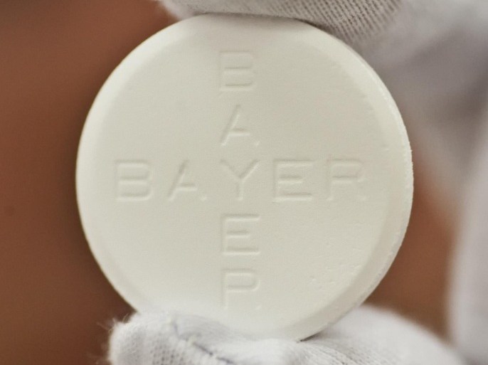 In this photo taken July 6, 2009 worker Roland Ulbrich presents an Aspirin pill made for Italy at the pharmaceutical plant of the Bayer Bitterfeld company in Bitterfeld-Wolfen, eastern Germany. Germany's Bayer AG says it plans to buy U.S. pharmaceutical company Merck & Co. Inc.'s consumer care business, whose products include the Coppertone suncare range, Claritin allergy medicine and the Dr. Scholl's footcare products, for US$ 14.2 billion. (AP Photo/Eckehard Schulz)
