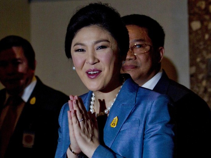 Thai Prime minister Yingluck Shinawatra arrives at the Constitutional Court in Bangkok, Thailand, Tuesday, May 6, 2014. Yingluck defended herself Tuesday against abuse of power allegations in a crucial court case that is one of several legal challenges which could remove her from office. She is accused of abusing her authority by transferring her National Security Council chief in 2011 to another position. (AP Photo/Sakchai Lalit)