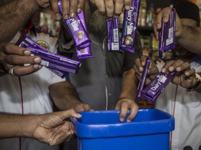 Malaysian Muslim Consumer Association members throw Cadbury Dairy Milk bars into a thrash bin during a protest against Cadbury products, at a press conference in Kuala Lumpur, Malaysia, 29 May 2014. More than a dozen Muslim organizations urged a boycott against chocolate-maker Cadbury after two of its products sold in predominantly Islamic Malaysia were found to contain pork DNA. Cadbury's Malaysia recalled two batches of Cadbury Dairy Milk Hazelnut and Cadbury Dairy Milk Roast Almond, which the Health Ministry found on to contain traces of porcine DNA.