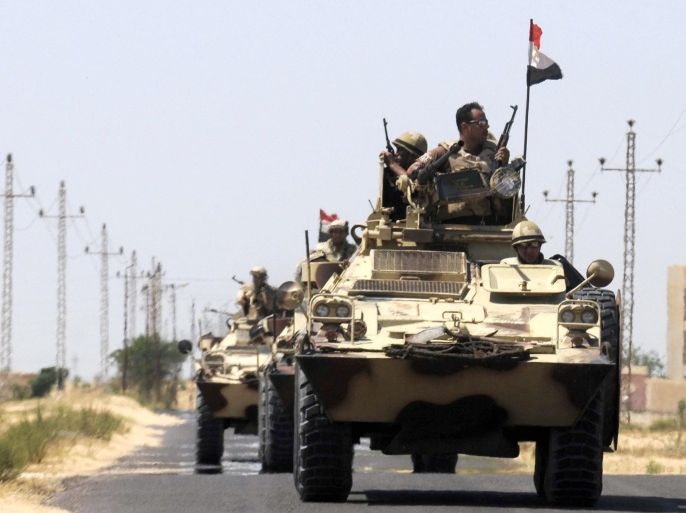(FILE) Armored personnel carriers (APC) of the Egyptian Army patrol on a road close to El Gorah in northeastern Sinai, Egypt, 21 May 2013. According to media reports on 23 May 2014, Shadi al-Menei, an Islamist leader of the Ansar Beit al-Maqdis militant group was shot dead in the Sinai Peninsula. The militant group was linked to al-Qaeda-inspired groups and alleged to be responsible of terrorist attacks killing more than 200 Egyptian soldiers since July 2013 after Egyptian President Mohammed Morsi was ousted.