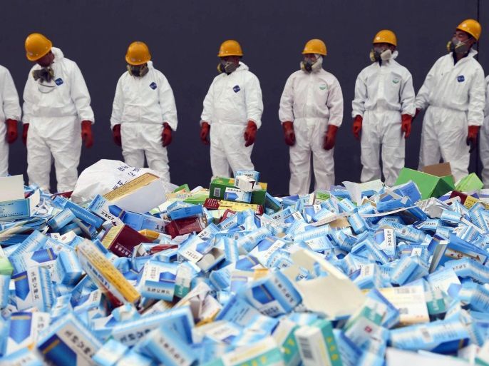 This picture taken on March 14 shows health workers preparing to destroy fake medicines seized in Beijing in recent months. The rapid growth of Internet commerce has led to an explosion of counterfeit drugs sold around the world, with China the biggest source of fake medicines, pharmaceutical experts said as the illicit trade is now believed to be worth around 75 billion USD globally, with criminal gangs increasingly using the web to move their products across borders.