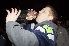 SEATTLE, WA - FEBRUARY 2: A Seattle Seahawks fan celebrates by drinking vodka straight out of the bottle after watching his team win the Super Bowl on February 2, 2014 in Seattle, Washington. The Seahawks defeated the Denver Broncos 43-8 in Super Bowl XLVIII.