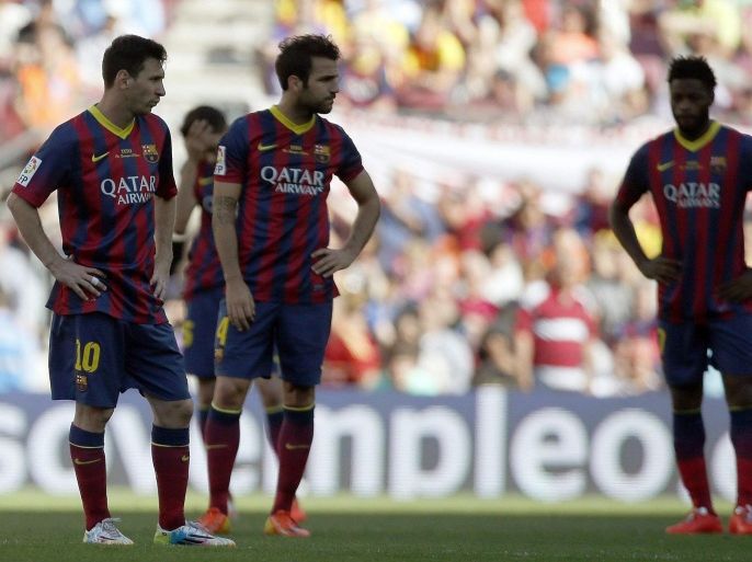 FC Barcelona's Argentinian striker Leo Messi (L) and midfielder Cesc Fabregas (2L) show their dejection after the draw 2-2 with Getafe FC at the end of the Primera Division soccer match played at Camp Nou stadium in Barcelona, Catalonia, Spain on 03 May 2014.
