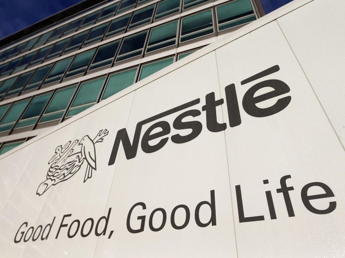 The Nestle logo is pictured on a truck outside the company's headquarters before the nine-month sale figures news conference in Vevey October 17, 2013. REUTERS/Denis Balibouse