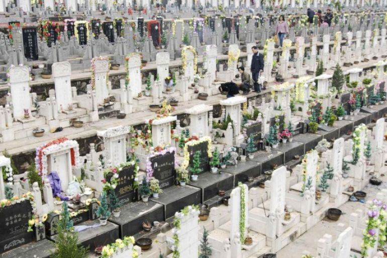 Residents pay respects at tombstones at a public grave before the Qingming festival in Xiangfan, Hubei province March 30, 2008. The Qingming festival, also known as Tomb-sweeping Day, will fall on April 4 and is a day for the Chinese to remember and honour their ancestors.