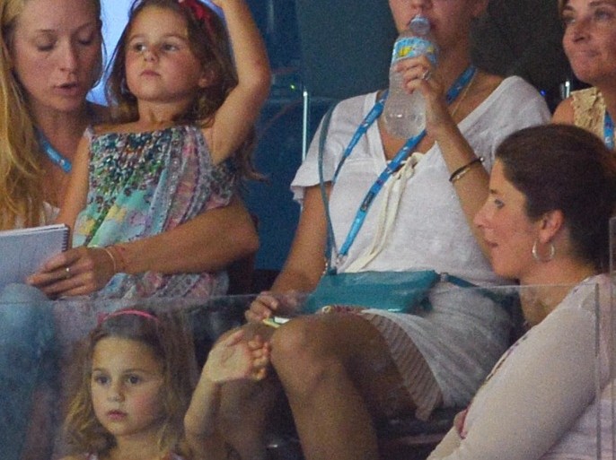Mirka Federer (lower R) watches alongside family members and entourage as her husband Roger Federer plays against Marinko Matosevic of Australia at the Brisbane International tennis tournament in Brisbane on January 3, 2014. AFP PHOTO/William WEST -- IMAGE RESTRICTED TO EDITORIAL USE - STRICTLY NO COMMERCIAL USE --