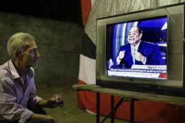 An Egyptian watches a televised interview of former army chief Abdel-Fattah el-Sissi at a coffee shop in downtown Cairo, Egypt, late Tuesday, May 6, 2014. El-Sissi gave a TV interview of his campaign to become Egypt's next president , saying he decided to run because of the threats facing the nation after his removal of the country's first democratically elected president, Islamist Mohammed Morsi. (AP Photo/Amr Nabil)