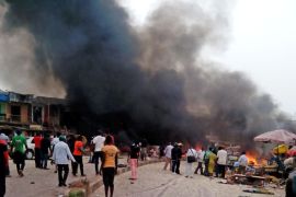Smoke rises after a bomb blast at a bus terminal in Jos, Nigeria, Tuesday, May 20, 2014. Two explosions ripped through a bustling bus terminal and market frequented by thousands of people in Nigeria's central city of Jos on Tuesday afternoon, and police said there are an unknown number of casualties. The blasts could be heard miles away and clouds of black smoke rose above the city as firefighters and rescue workers struggled to reach the area as thousands of people fled. (AP Photo/Stefanos Foundation)