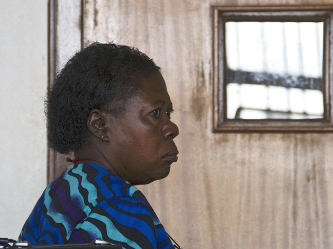 Ugandan nurse Rosemary Namubiru sits at the dock at the Buganda Road Magistrates Court on May 19, 2014 in Kampala during a ruling on a case where she was charged with 'Criminal Negligence' and sentenced to 3 years in prison after she was found guilty by the Ugandan court. Mrs Mamubiru, 64, who is HIV positive, allegedly transmitted the HIV virus to a 2 years old toddler with a contaminated needle after she pricked herself unknowingly. AFP PHOTO/ ISAAC KASAMANI