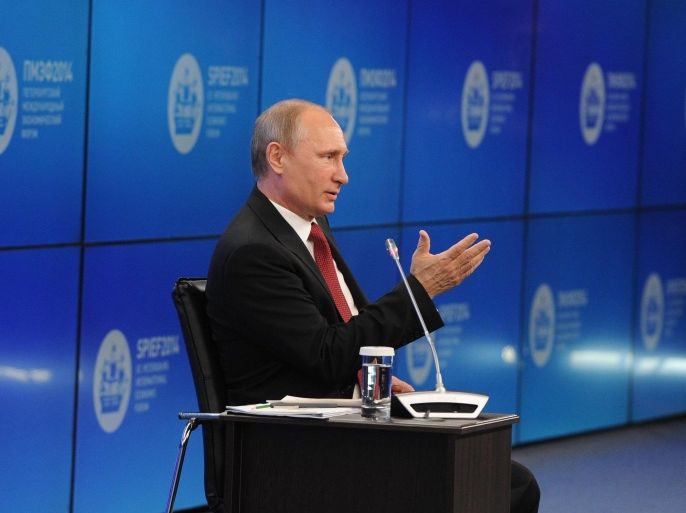 Russian President Vladimir Putin speaks during a plenary session of the St. Petersburg International Investment Forum Friday, May 23, 2014. Speaking at the investment forum, Putin blamed the West for encouraging a “coup” in Ukraine, when the nation’s pro-Russian president was chased from power after months of protests. He said that Ukraine is now facing “chaos and a full-scale civil war.” (AP Photo/RIA Novosti Kremlin, Mikhail Klimentyev, Presidential Press Service)