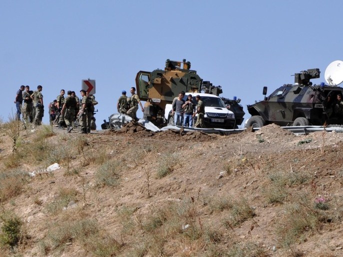 Turkish special police forces and soldiers check the road where eight police officers have been killed and nine were wounded in a roadside mine blast in the southern Turkish province of Bingol, on September 16, 2012. The members of the outlawed Kurdistan Workers' Party (PKK) launched the attack around 0715 GMT as a police vehicle was passing in the Karliova district of Bingol province, local security sources said. The latest attack comes amid an ongoing army operation against Kurdish rebels in the southeast that has been concentrated in the Semdinli district in Hakkari province and has included nearly 5,000 ground troops, according to the Turkish military.