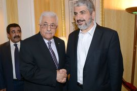 A handout picture released by the Palestinian Press Office (PPO) shows Palestinian leader Mahmud Abbas (L) shaking hands with political bureau head of Hamas, Khaled Meshaal on May 5, 2014 in Doha, Qatar following their first meeting since their rival movements signed a surprise unity deal. The last time the two leaders met face-to-face was in Cairo in January 2013. AF