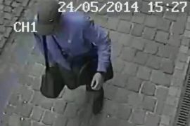 In this hand out photo distributed on Sunday, May 25, 2014 by the Belgian Federal Police, a surveillance camera shows the suspected killer, walking along, near the Jewish museum in Brussels, Saturday, May 24, 2014. Police stepped up security at Jewish institutions, schools and synagogues after three people were killed and one seriously injured in a spree of gunfire at the Jewish Museum in Brussels on Saturday. (AP Photo/Belgian Federal Police, hand out)