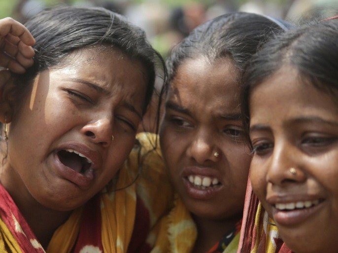 Relatives of victims killed in ethnic violence mourn at a burial ground at Narayanguri village, in the northeastern Indian state of Assam, Saturday, May 3 2014. Police in India arrested 22 people after separatist rebels went on a rampage, burning homes and killing dozens of Muslims in the worst outbreak of ethnic violence in the remote northeastern region in two years, officials said Saturday. (AP Photo/Anupam Nath)