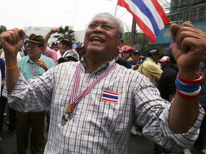 Thai anti-government protest leader Suthep Thaugsuban is greeted by his supporters during a march in Bangkok, Thailand, Monday, May 19, 2014. Earlier this month, the country's political crisis deepened after the Constitutional Court removed caretaker Prime Minister Yingluck Shinawatra for nepotism along with nine Cabinet members in a case that many viewed as politically motivated. Protesters are now pushing for her successor and the rest of the government to be replaced by an interim administration.(AP Photo/Sakchai Lalit)